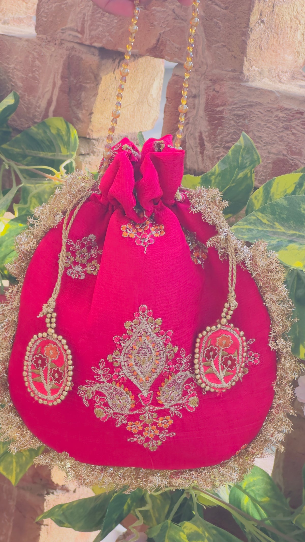 Rukhsaar: Hot Pink Silk Potli with Hand-Embroidered Gold Motifs & Fringe Border