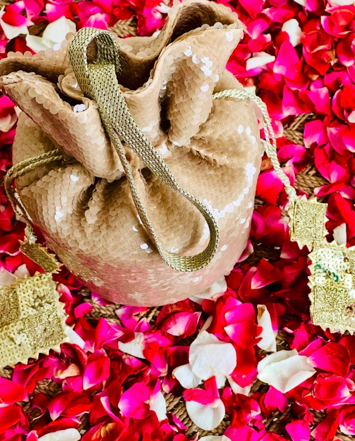 Sohaan: Champagne Gold Sequin Bucket Bag with Handcrafted Gota Tassels