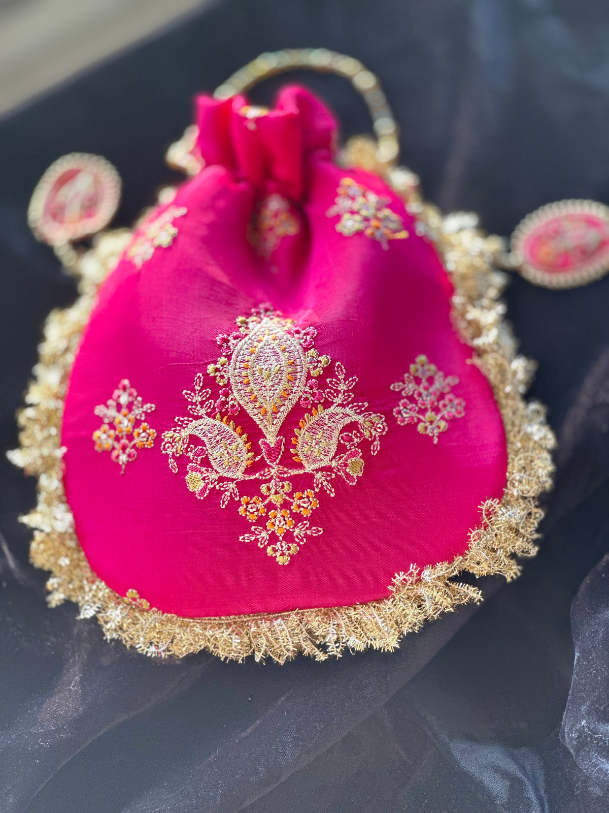Rukhsaar: Hot Pink Silk Potli with Hand-Embroidered Gold Motifs & Fringe Border