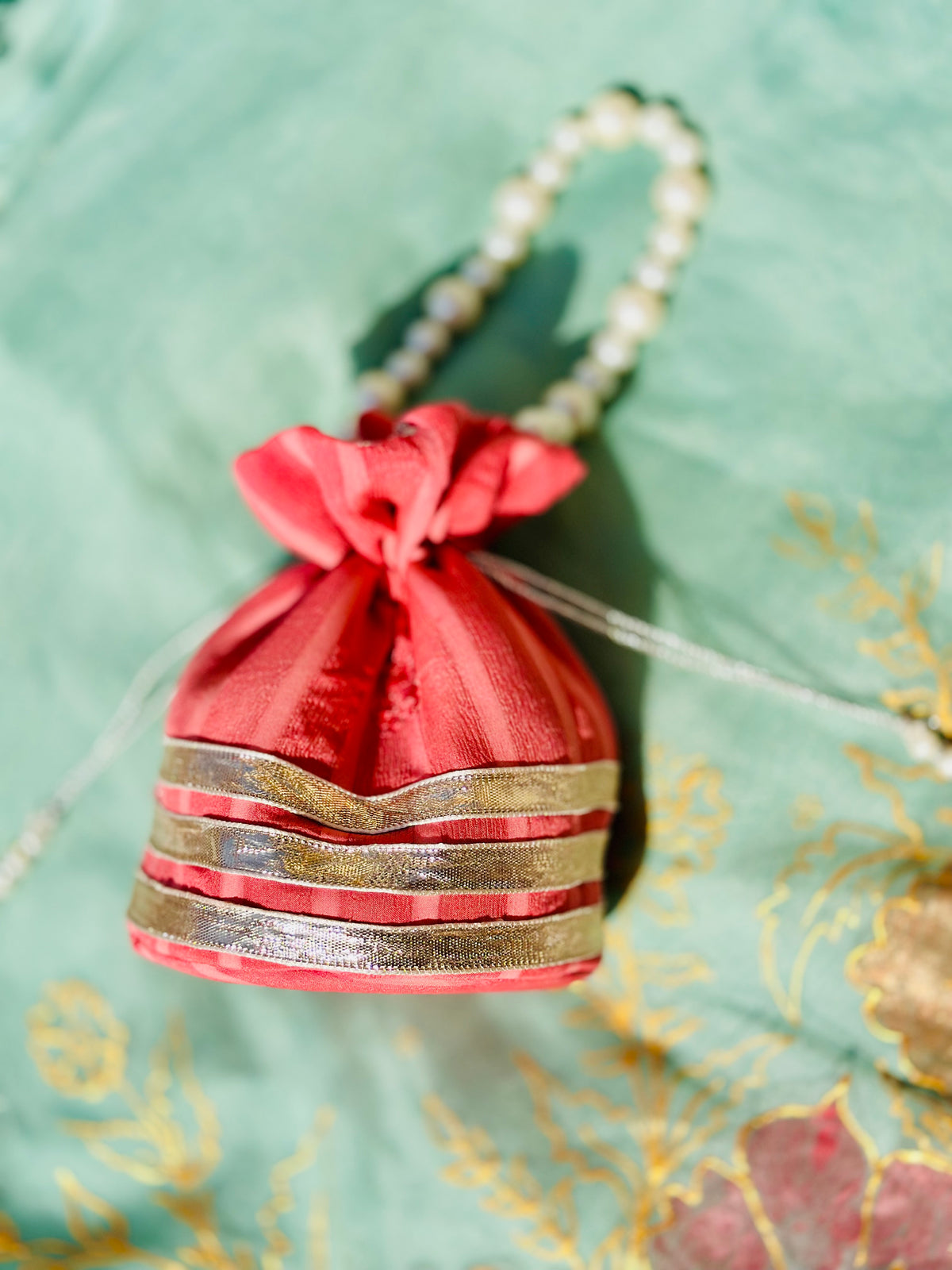 Handcrafted Coral Chiffon Potli Bag with Pearl Handle & Silver Gota Lace - Striped Festive Clutch