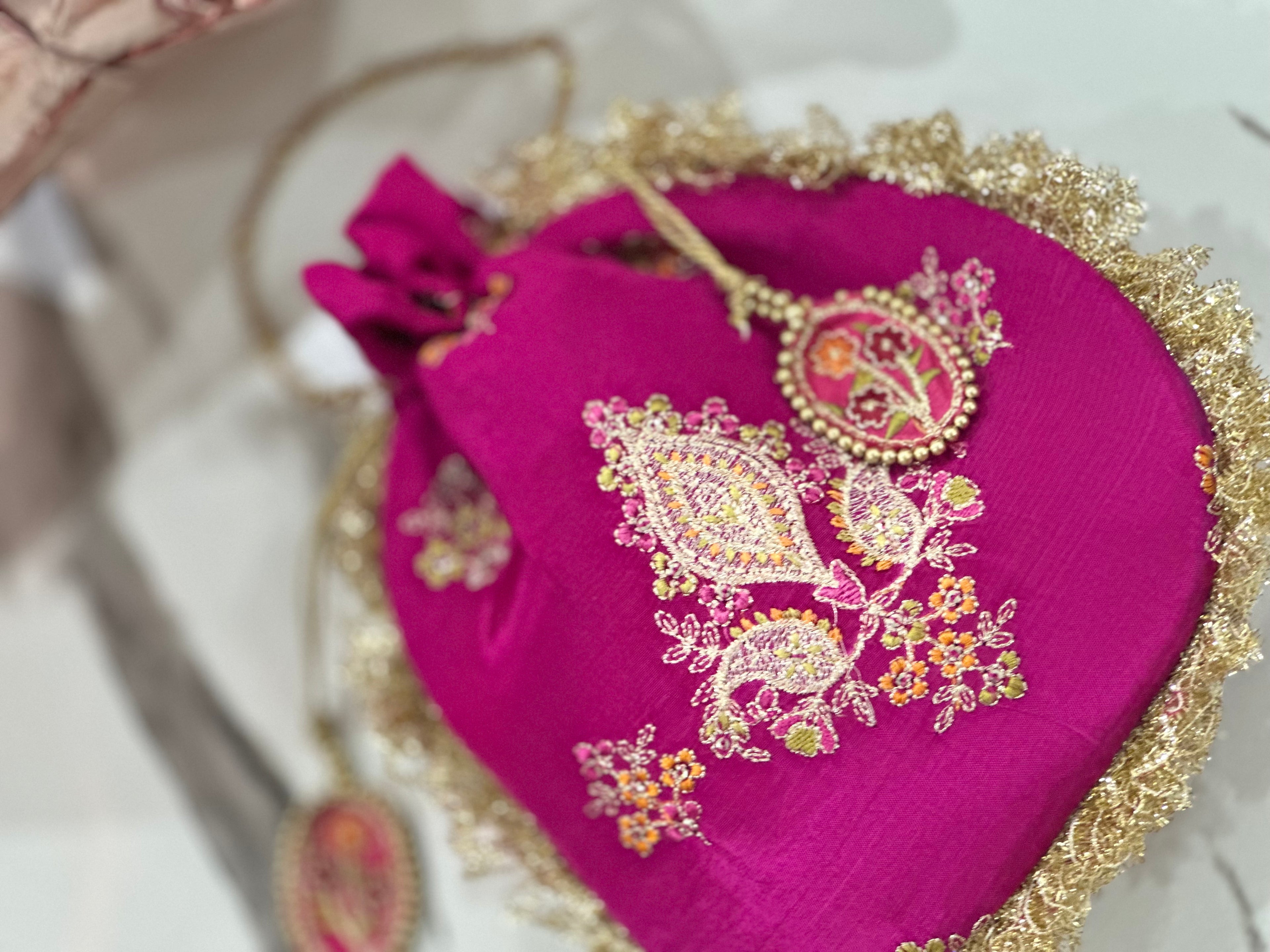 Rukhsaar: Hot Pink Silk Potli - Gold Motifs & Fringes