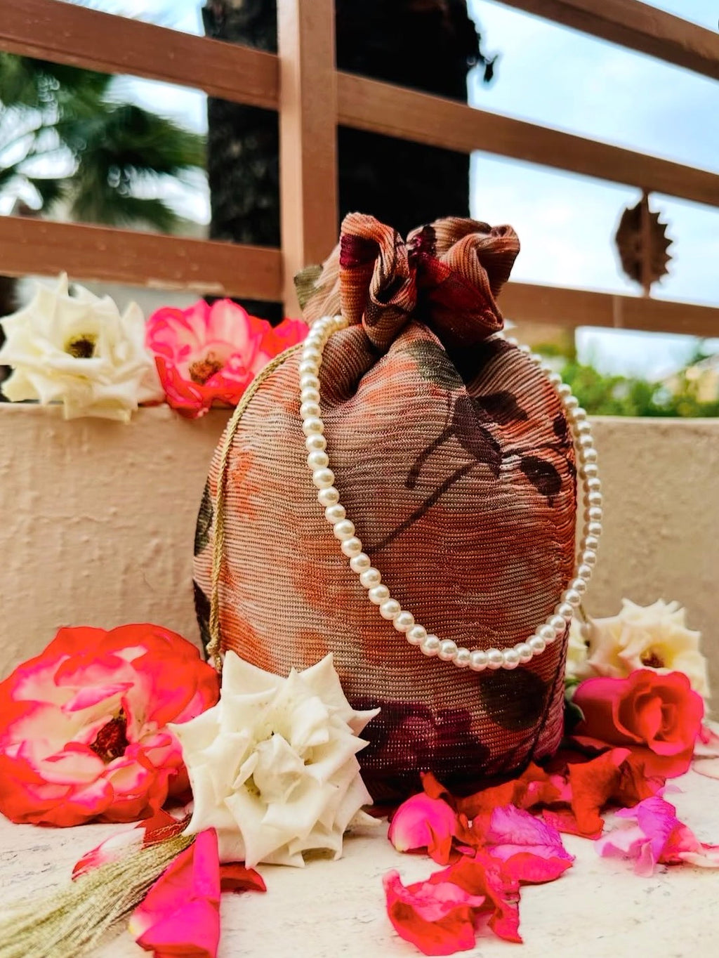 Zeenia: Crushed Georgette Potli Bag with Pearl Handle - Peach