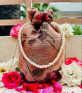 Zeenia: Crushed Georgette Potli Bag with Pearl Handle - Peach