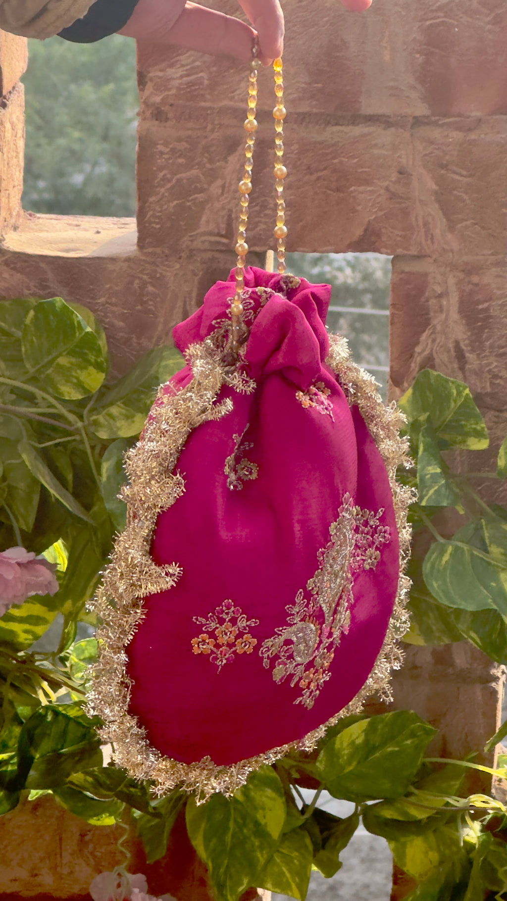 Rukhsaar: Hot Pink Silk Potli with Hand-Embroidered Gold Motifs & Fringe Border