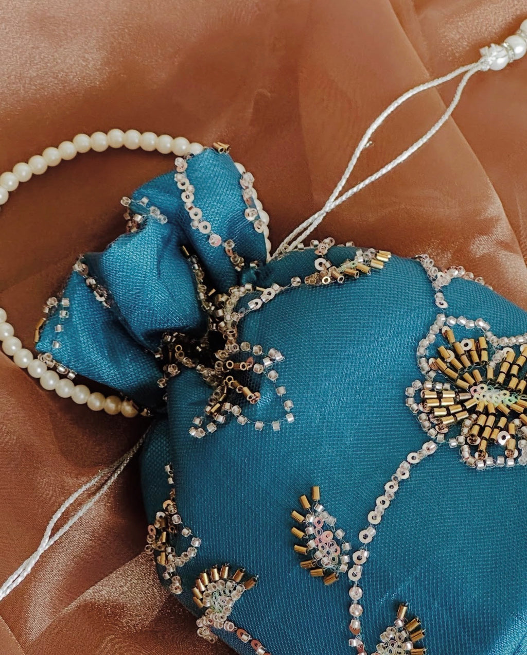 Roshan Aara: Teal Net Potli with Gold Cutdana Embroidery