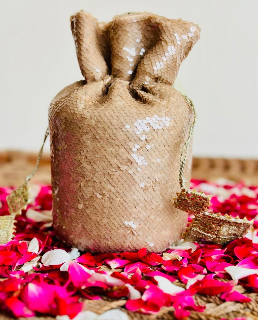 Sohaan: Champagne Gold Sequin Bucket Bag with Gota Tassels