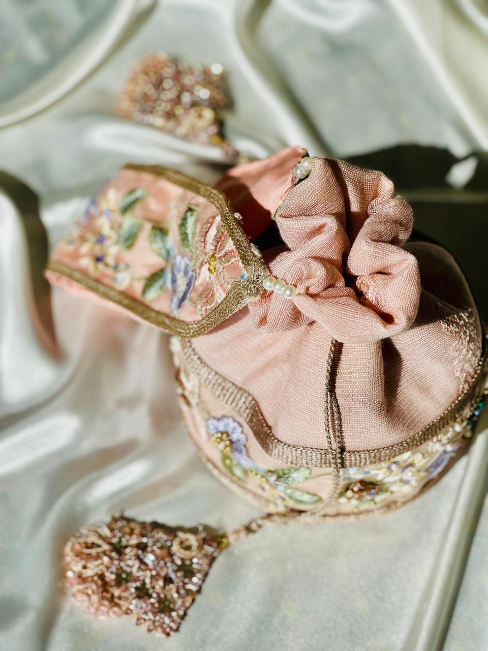 Mah-e-Zar: Pink Net Potli with Floral Appliqué & Tassels